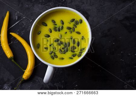 Pumpkin Asian Coconat Cream Soup. Autumn Hot Food. Chili Pepper, Garlic, Red Onion, Big Pumpkin. Dar