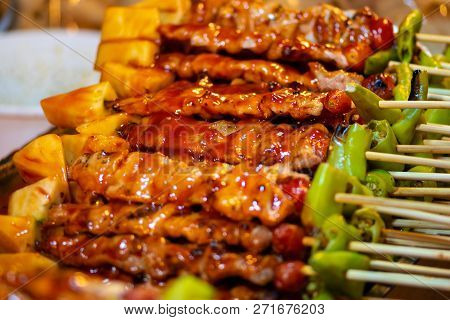 Barbecue Chicken Skewers In Red Sauce, Thai Street Food Background
