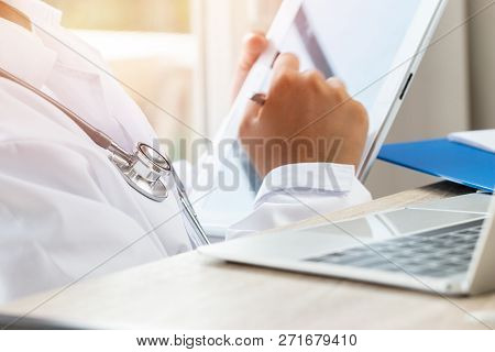 Healthcare Medical Hospital Concept : Doctor Intern Using Tablet Computer With Gown Suite Wearing St