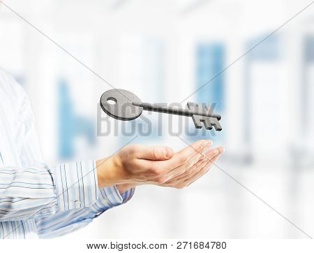 Cropped Image Of Businessman In Suit Keeping Stone Key Symbol In Hands. Mixed Media
