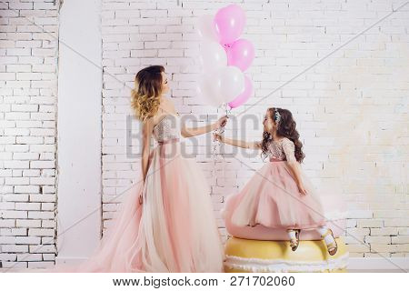 Mom And Daughter In Luxurious, Pink, Lush Dresses. Family Clothes, Identical Dresses. The Background