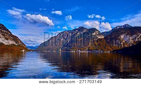 Panoramic Scenic View In Austrian Alps. Hallstatt Mountain Village At Hallstatt Lake. Sunny Day Lake