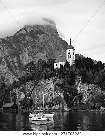 Vintage Black And White View Of Austrian Alps Lake. Boats, Yachts Infront Of Church On The Rock With