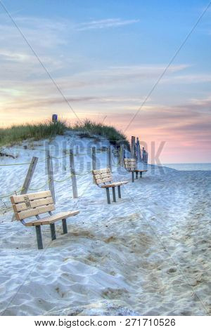 Benches Line The Dunes At Mayflower Beach At Sunset In Dennis, Cape Cod In Massachusetts.