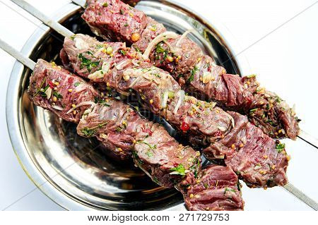 Raw Skewers Of Beef With Spices And Herbs