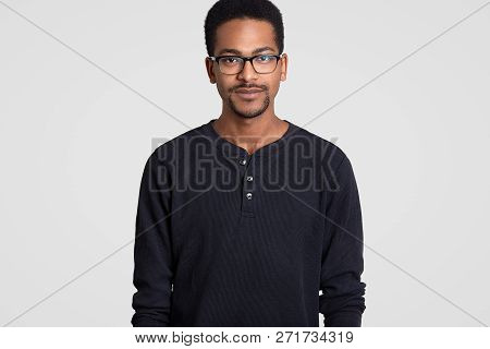Portrait Of Dark Skinned Young Businessman With Beard, Wears Transparent Glasses, Dressed In Casual 
