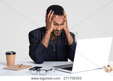 Overworked Tired Stressful Male Keeps Hands On Head, Lools With Puzzlement, Doesnt Know How To Prepa