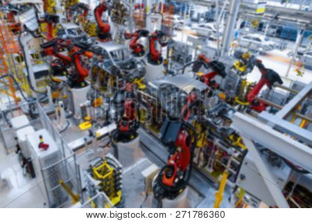 Vague Premise Of Assembly Line Production Of Cars. Defocused Image Of Car Factory