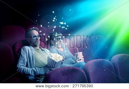 Teenager couple cuddling and watching the climax part of the movie