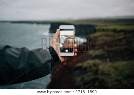 Hand Holds Smartphone To Make Photo Of Scenery