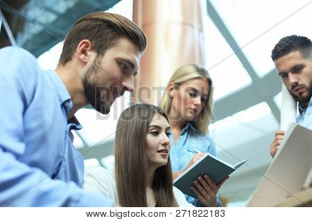 Group Of Young Modern People In Smart Casual Wear Having A Brainstorm Meeting While Standing In The 