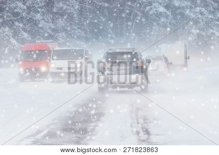 Winter, Snow, Blizzard, Poor Visibility On The Road. Car During A Blizzard On The Road With The Head