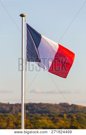 French Flag In Auvers-sur-oise Village With Forest In Background, France