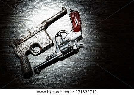 Old Revolver And Pistol Closeup On Dark Background