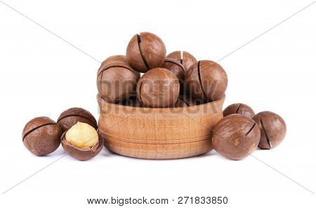 Macadamia Nuts In Wooden Plate, Isolated On White Background. Shelled And Unshelled Macadamia.