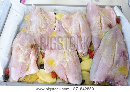 Fish Filet With Potatoes And Olives Cooking