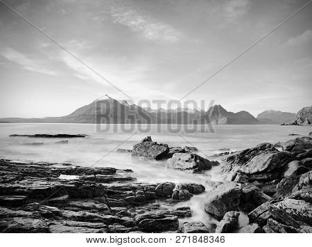 The Stony Beach And Cliff Of Rocky Bay. Blue Tones Of February Sunset, Pink Horizon.  Dark Slipery B