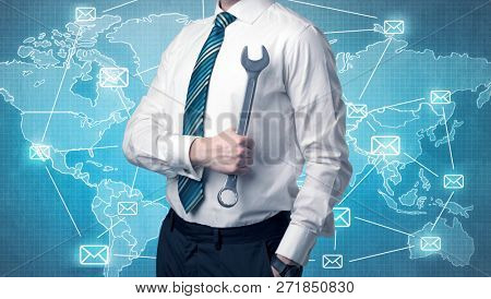 Businessman holding tool with global map graphic on the background