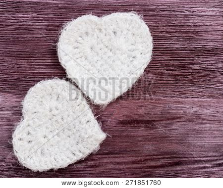 Picture Of Beautiful Handmade White Knitted Heart, Soft Heart Toy. Two Hearts On Bright Wooden Surfa