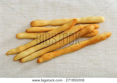 Tasty Dry Bread Italian Grissini On Light Fabric. Grissini Lies On Tablecloth. Horizontal Format. To