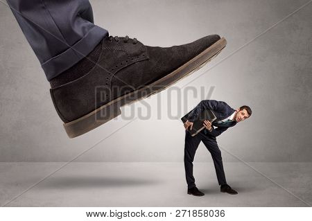 Young businessman illustrated inconsiderable by being trampled