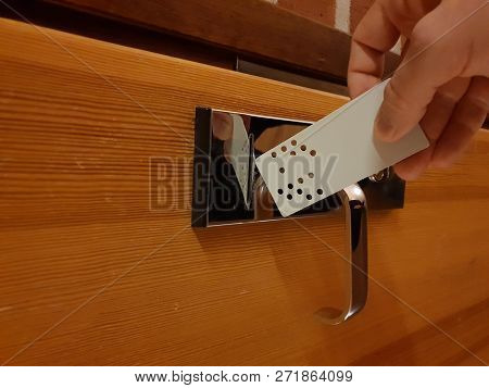 Image Of Analog Punchcard As A Key To Open Hotel Room Door