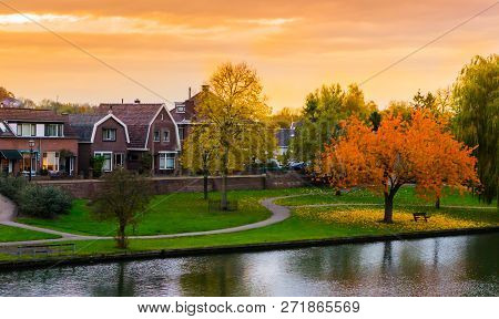 Leerdam The Netherlands, A Typical Dutch City View From The Park With Water, Road And Grass At Sundo
