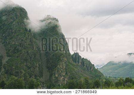 Thick Fog In Mountains With Copy Space On Mist. Vintage Foggy Landscape Of Majestic Nature In Faded 