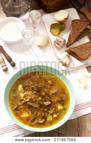 Rassolnik, Traditional Russian Soup, Served With Various Snacks And Vodka. Rustic Style.