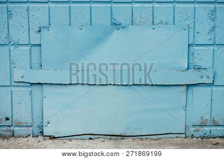 Blue Hatchway In Wall Of Building Close Up With Copy Space. Background Of Cyan Closed Hatch On Tiles