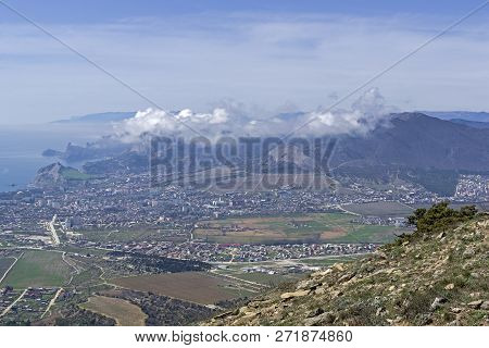 The Tops Of The Mountains Are Covered With Clouds. View From The Top Of Mount Ai-george (the Western