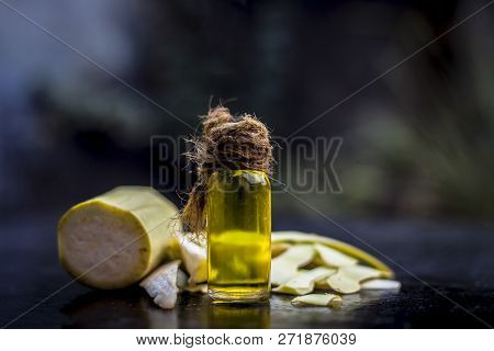 Close Up Of Essential Oil Of Bottle Gourd Or Dudhi Or  Calabash In A Transparent Glass Botlle On Woo