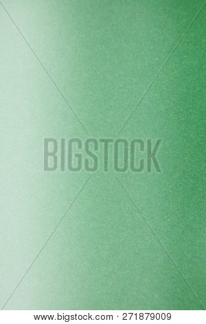 Green Colored Construction Paper. Close up view of Colored Construction Paper. Backgrounds and Textures. Opacity filter used to lighten and grade the image.
