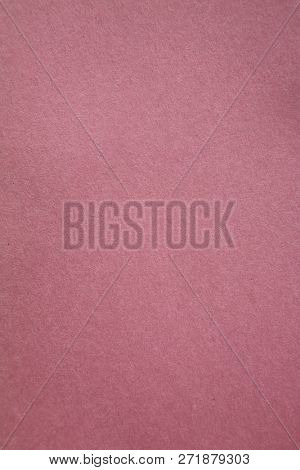 Pink Colored Construction Paper. Close up view of Colored Construction Paper. Backgrounds and Textures. Opacity filter used to lighten and grade the image.



