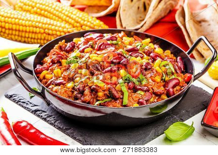 Chili Con Carne In A Clay Bowl On A Concrete Or Stone Rustic Background- Traditional Dish Of Mexican