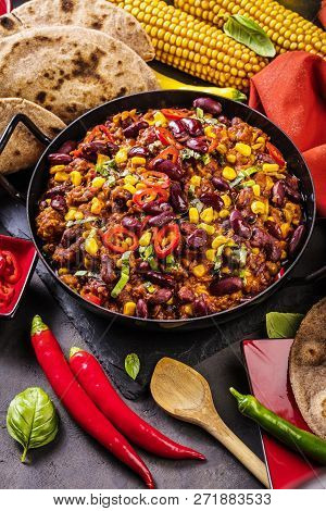 Chili Con Carne In A Clay Bowl On A Concrete Or Stone Rustic Background- Traditional Dish Of Mexican
