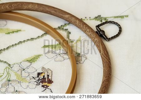Wooden Embroidery Hoop With Fragment Of Colorful Cross-stitch Embroidery Close-up, Summer Flower Orn