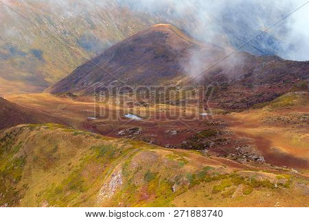 Clouds-covered High Mountain Valley With A Lake, Aerial View