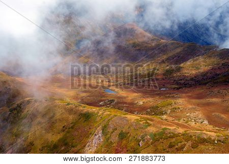 Clouds-covered High Mountain Valley With A Lake, Aerial View