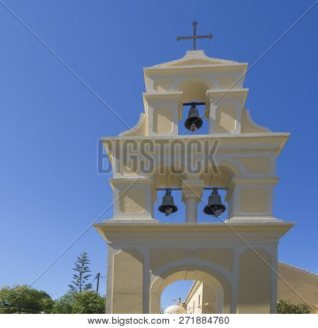 Traditional Greek Freestanding Bell Tower At Church In Sidari, Yellow White Belfry With Three Bells 
