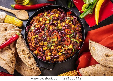 Chili Con Carne In A Clay Bowl On A Concrete Or Stone Rustic Background- Traditional Dish Of Mexican
