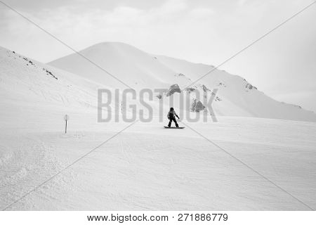 Snowboarder Downhill On Snowy Ski Slope And Mountains In Fog At Gray Winter Day. Georgia, Region Gud