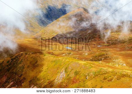 Clouds-covered High Mountain Valley With A Lake, Aerial View