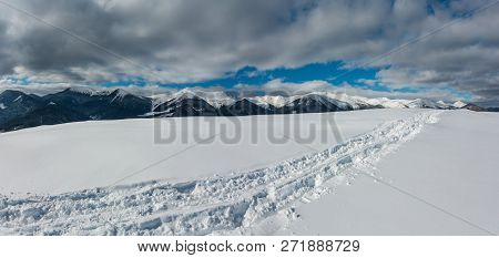 Sledge Trace And Footprints On Winter Mountain Hill Top And Snow Covered Picturesque Alp Chornohora 