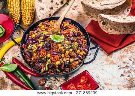 Chili Con Carne In A Clay Bowl On A Concrete Or Stone Rustic Background- Traditional Dish Of Mexican