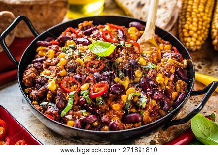Chili Con Carne In A Clay Bowl On A Concrete Or Stone Rustic Background- Traditional Dish Of Mexican