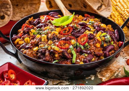 Chili Con Carne In A Clay Bowl On A Concrete Or Stone Rustic Background- Traditional Dish Of Mexican