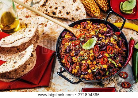 Chili Con Carne In A Clay Bowl On A Concrete Or Stone Rustic Background- Traditional Dish Of Mexican