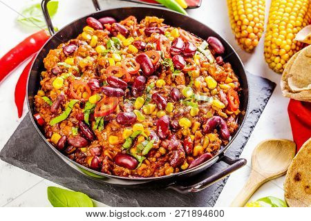 Chili Con Carne In A Clay Bowl On A Concrete Or Stone Rustic Background- Traditional Dish Of Mexican