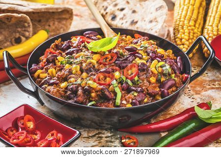 Chili Con Carne In A Clay Bowl On A Concrete Or Stone Rustic Background- Traditional Dish Of Mexican